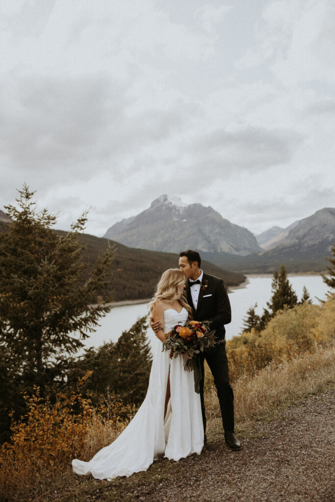 groom kissing the bride on the forehead