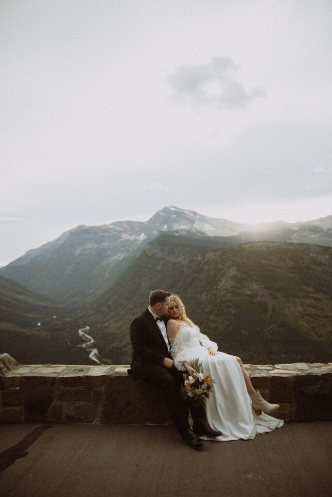 groom kissing the bride on the forehead during their photoshoot