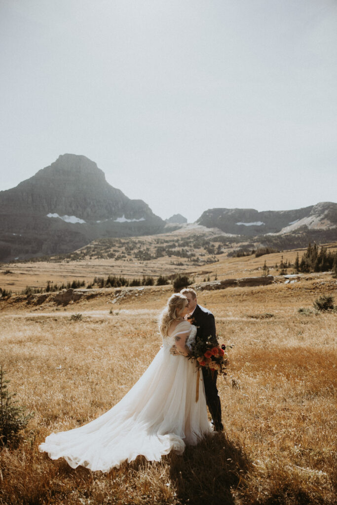 groom kissing the bride on the cheek during their photoshoot