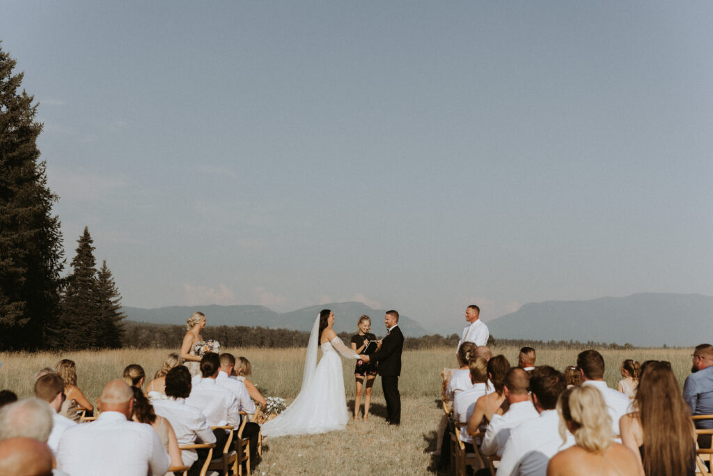 Picture of the bride and groom holding hands at their ceremony