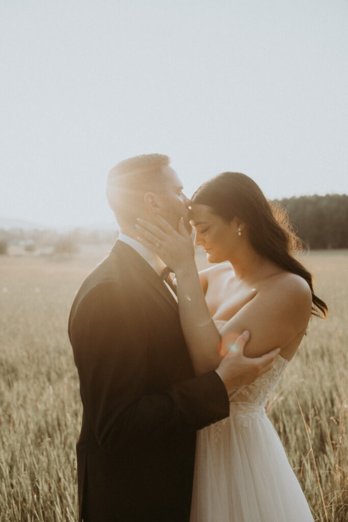 groom kissing the bride on the forehead