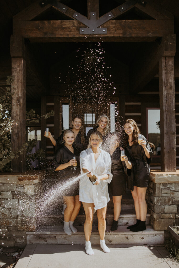bride her bridesmaids, drinking champagne