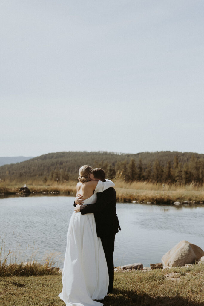 bride and groom hugging after her first look
