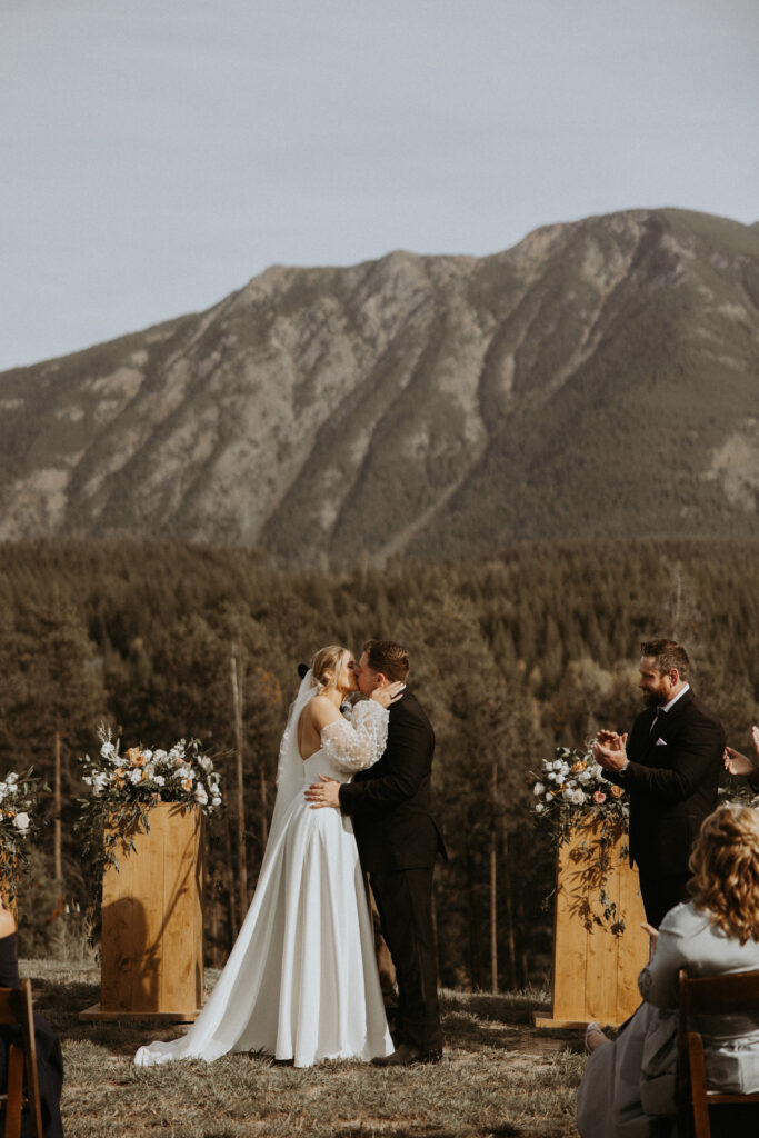 Bride and groom kissing after their wedding ceremony