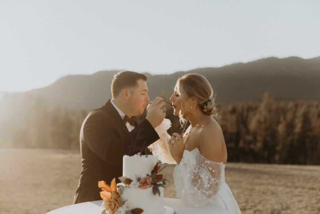 Newlyweds trying their wedding cake