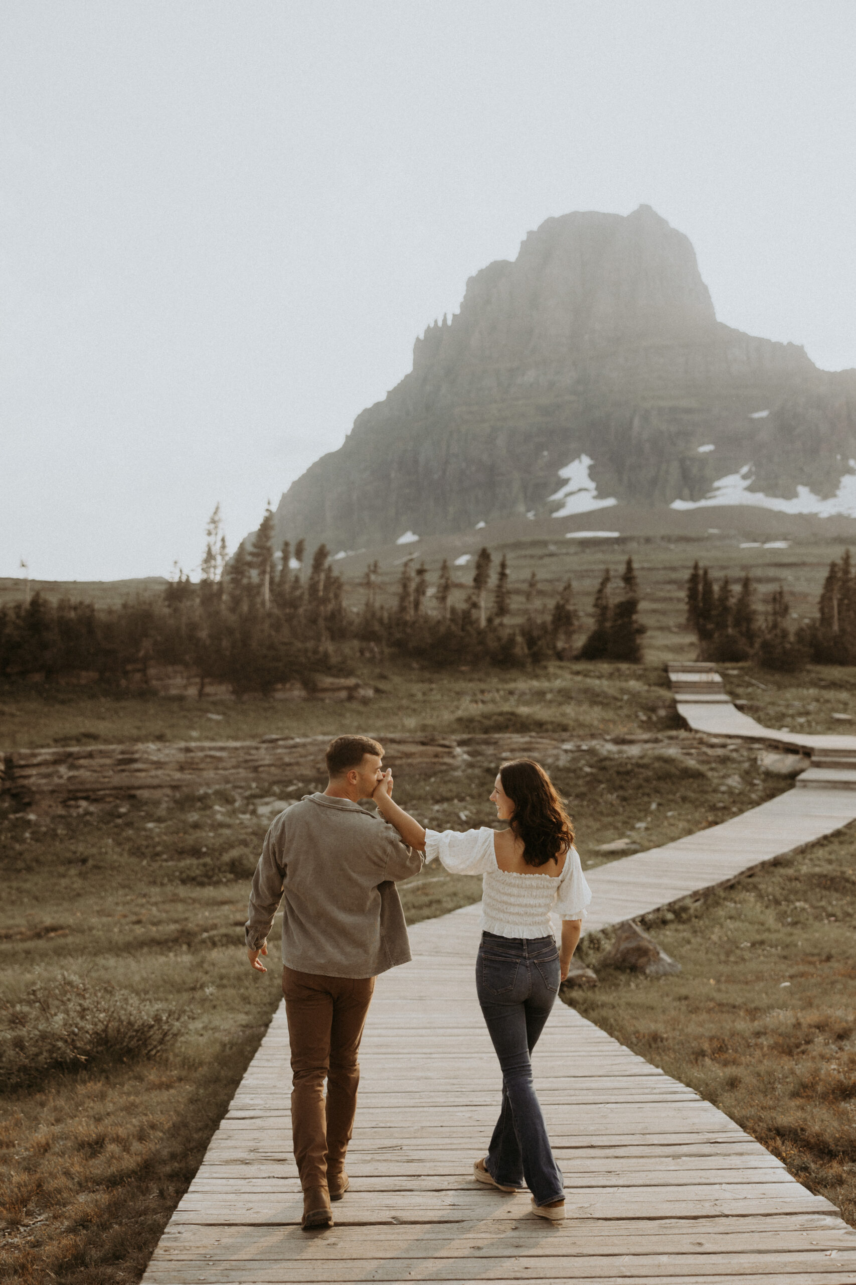 newly engaged couple holding hands during their photoshoot
