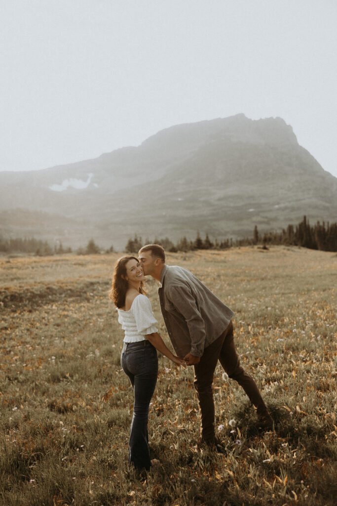 fiance kissing his fiance on the cheek