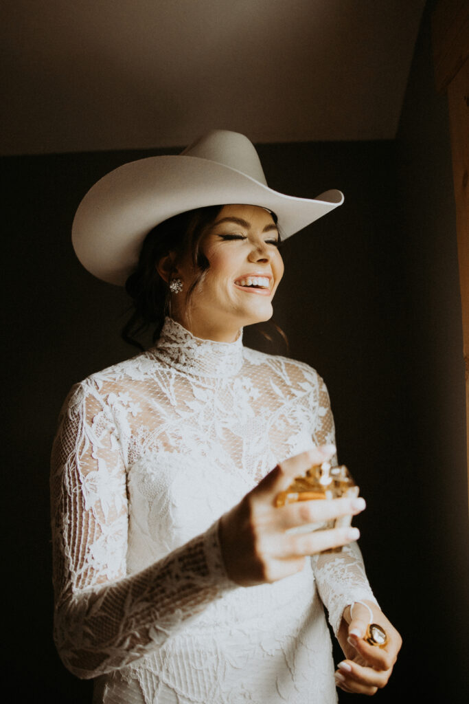 cute picture of the bride putting on perfume before her first look with the groom
