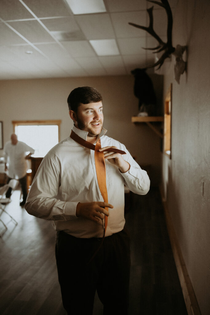 groom getting ready for his first look with the bride