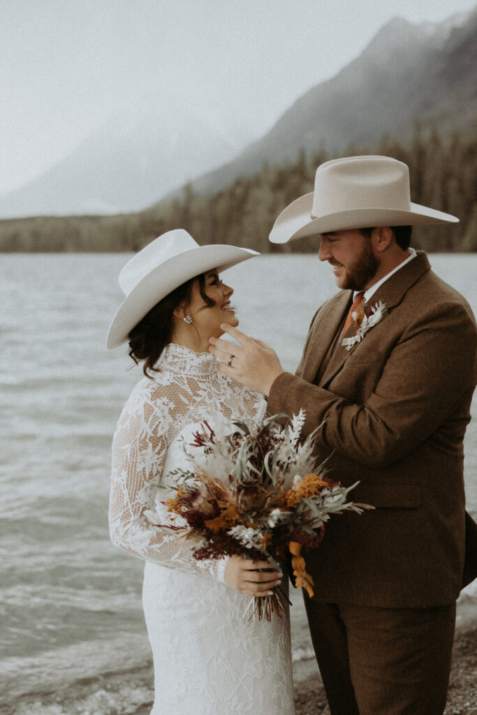 portrait of the bride and groom smiling at each other during their bridal portraits