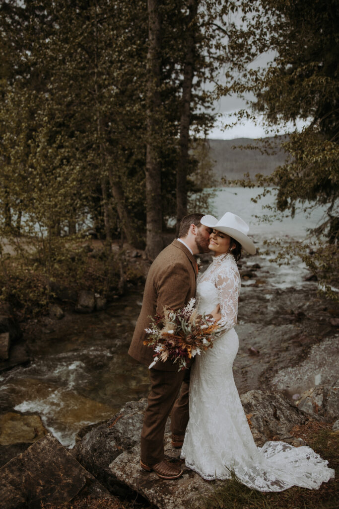 groom kissing the bride on the cheek