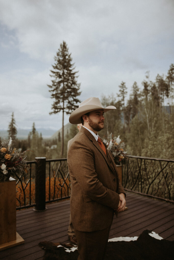 picture of the groom emotional watching the bride walk down the aisle