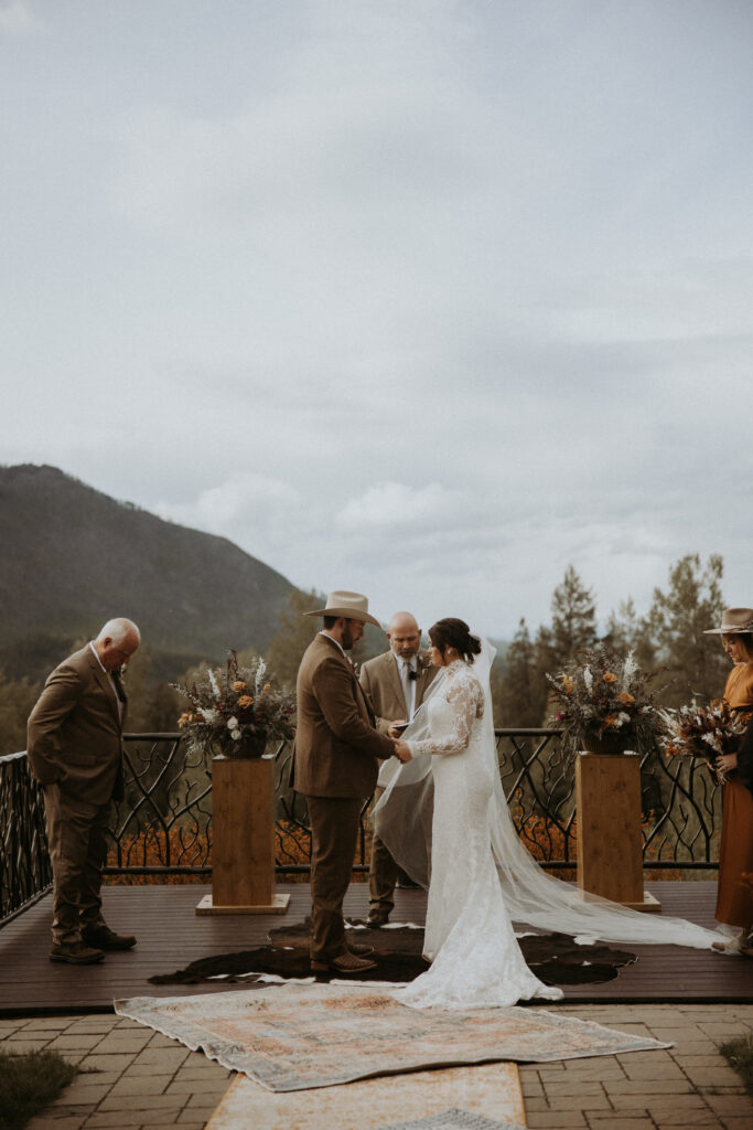 bride and groom holding hands during their ceremony