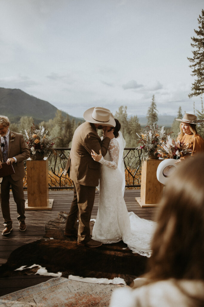 picture of the bride and groom kissing after their ceremony