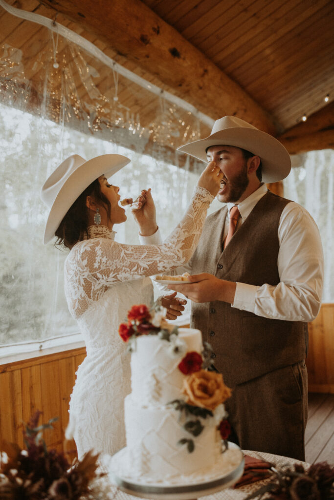 newlyweds trying their wedding cake