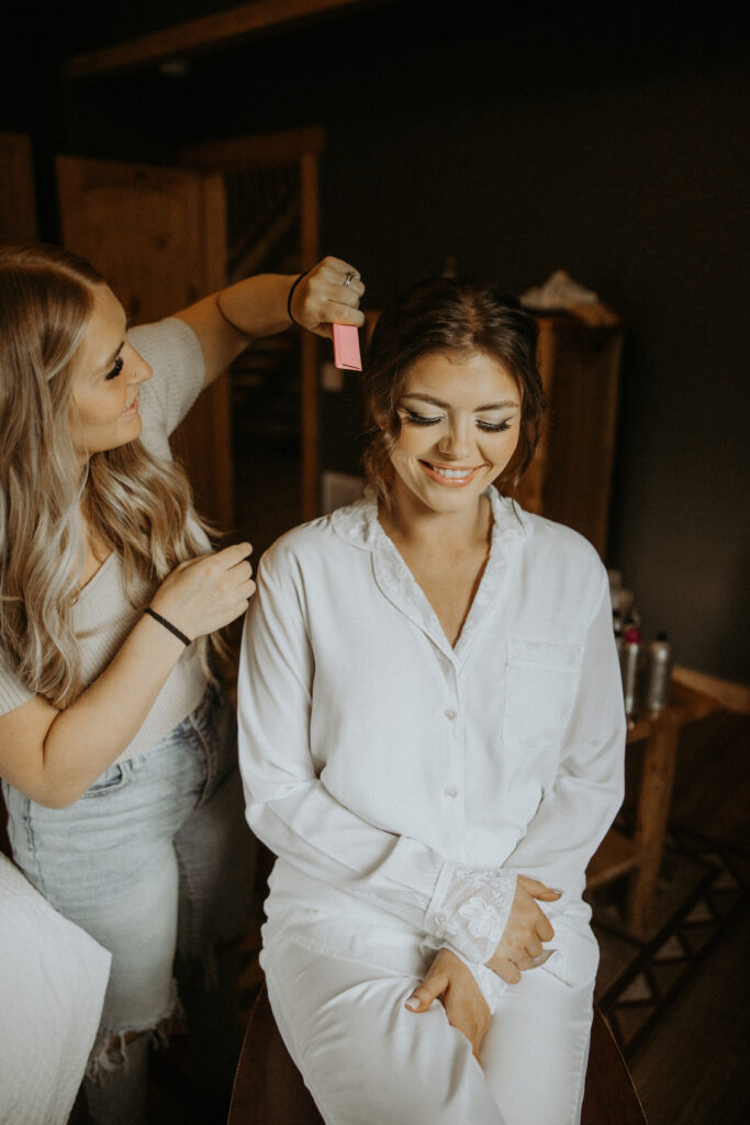 bride getting her makeup done before the ceremony