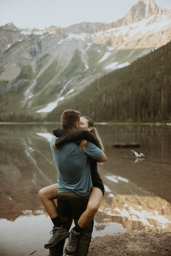 cute picture of the newly engaged couple kissing after their proposal