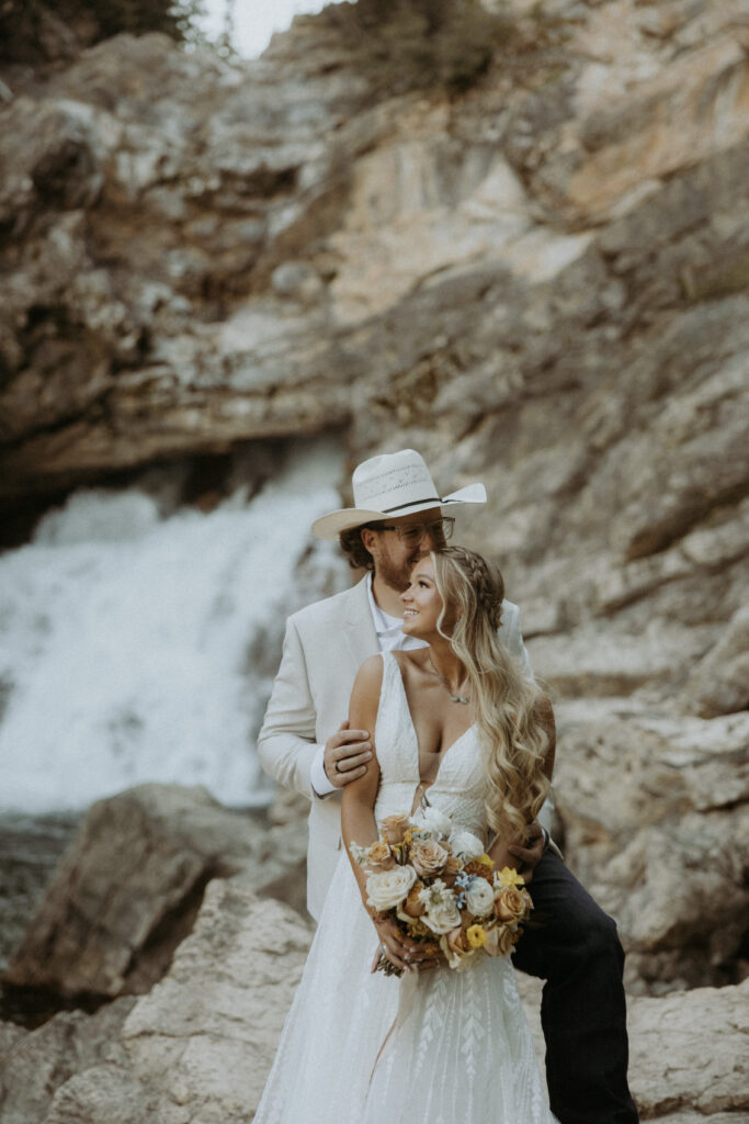 Groom, kissing the bride on the cheek