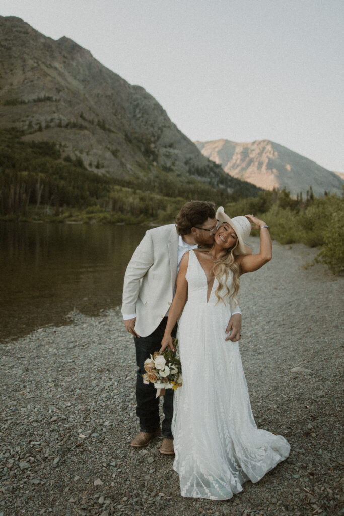Groom, kissing the bride on the neck