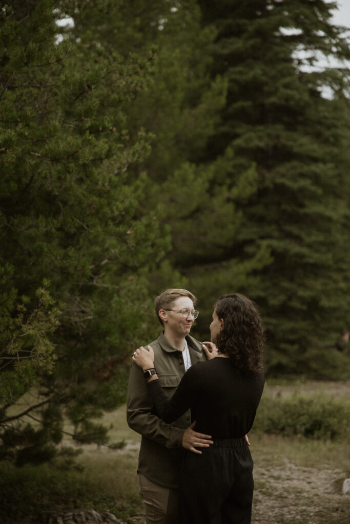 Cute picture of the newly engaged couple smiling at each other