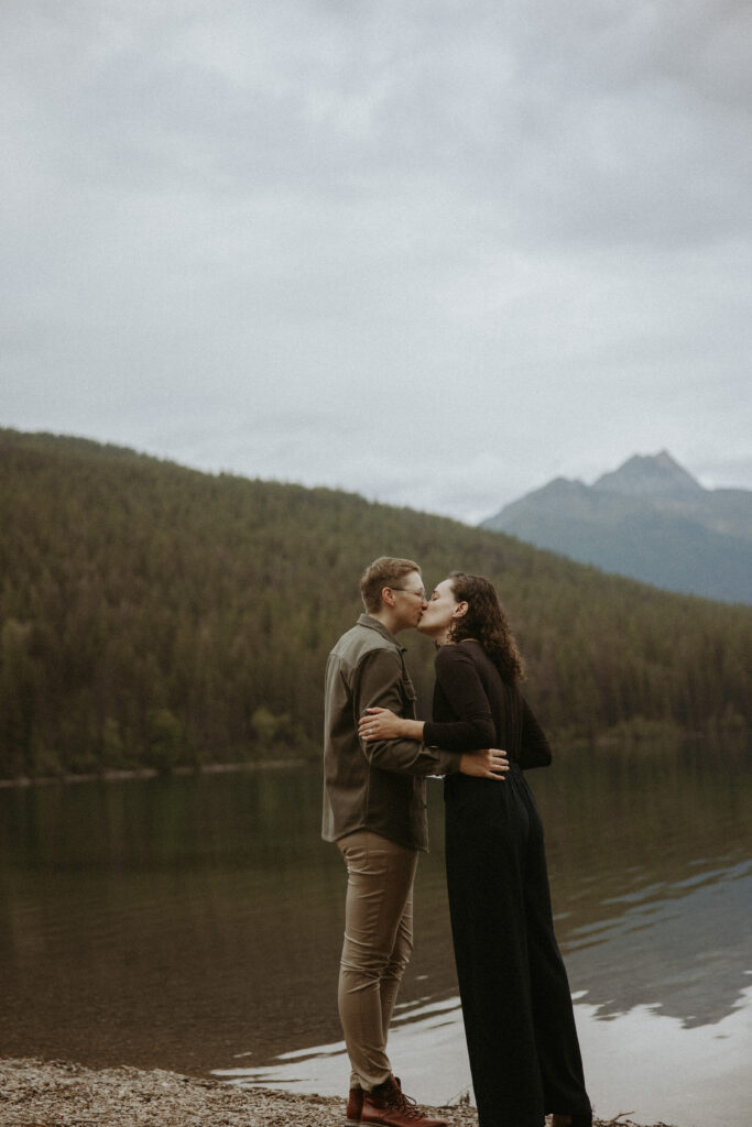 newly engaged couple kissing