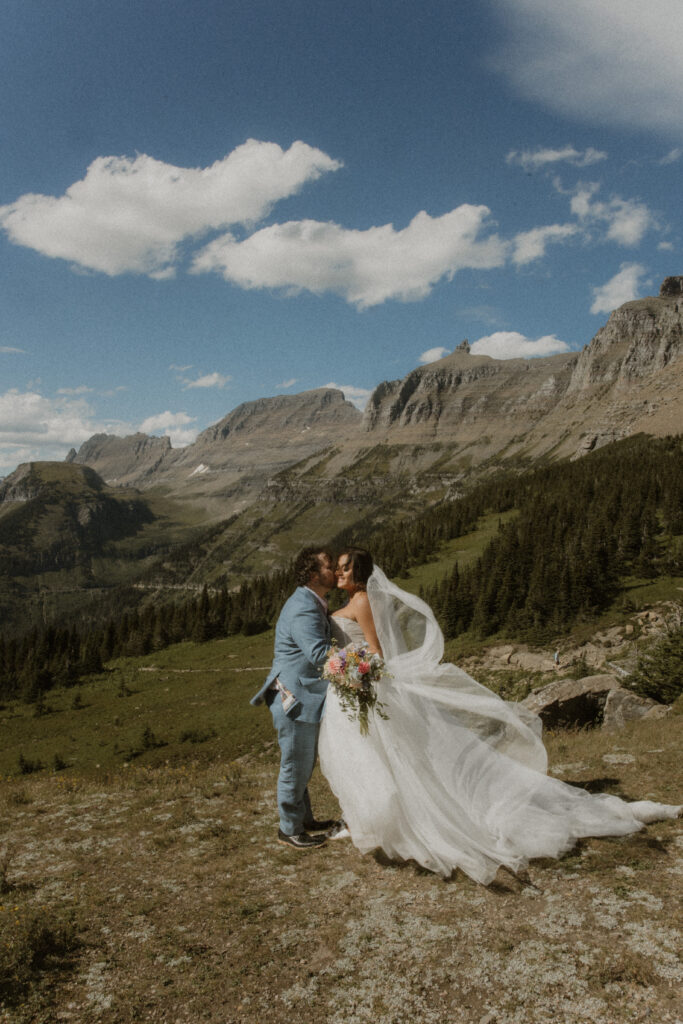 Groom, kissing the bride on the cheek