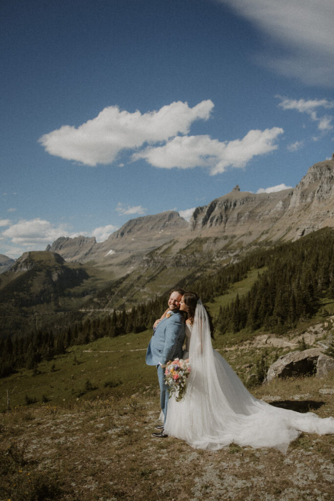 Bride, kissing the groom on the cheek