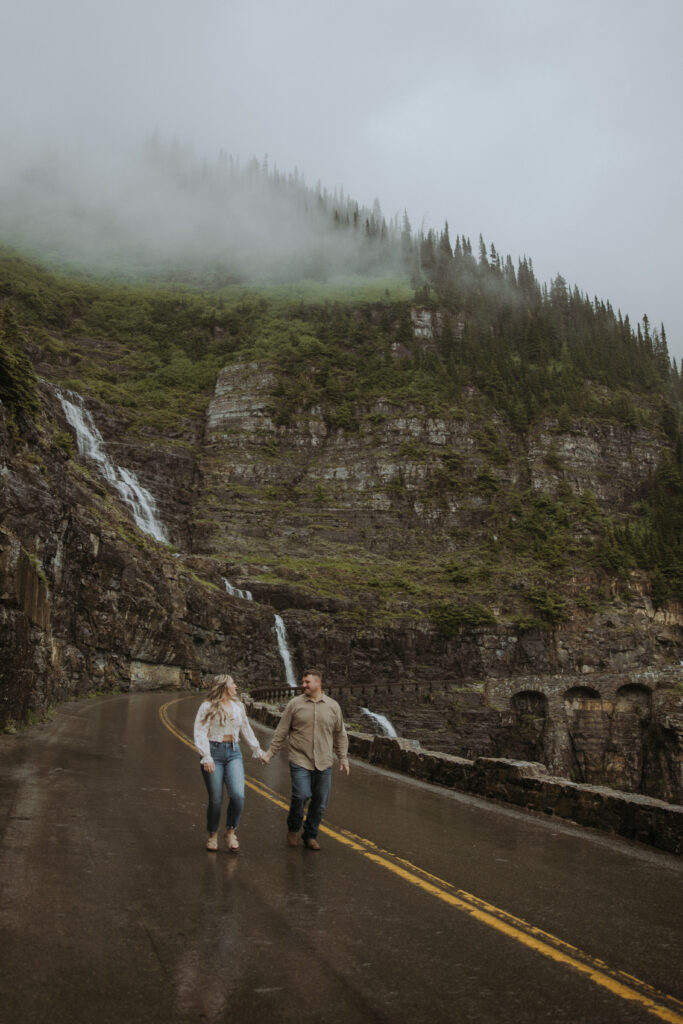 couple walking around glacier park during their engagement