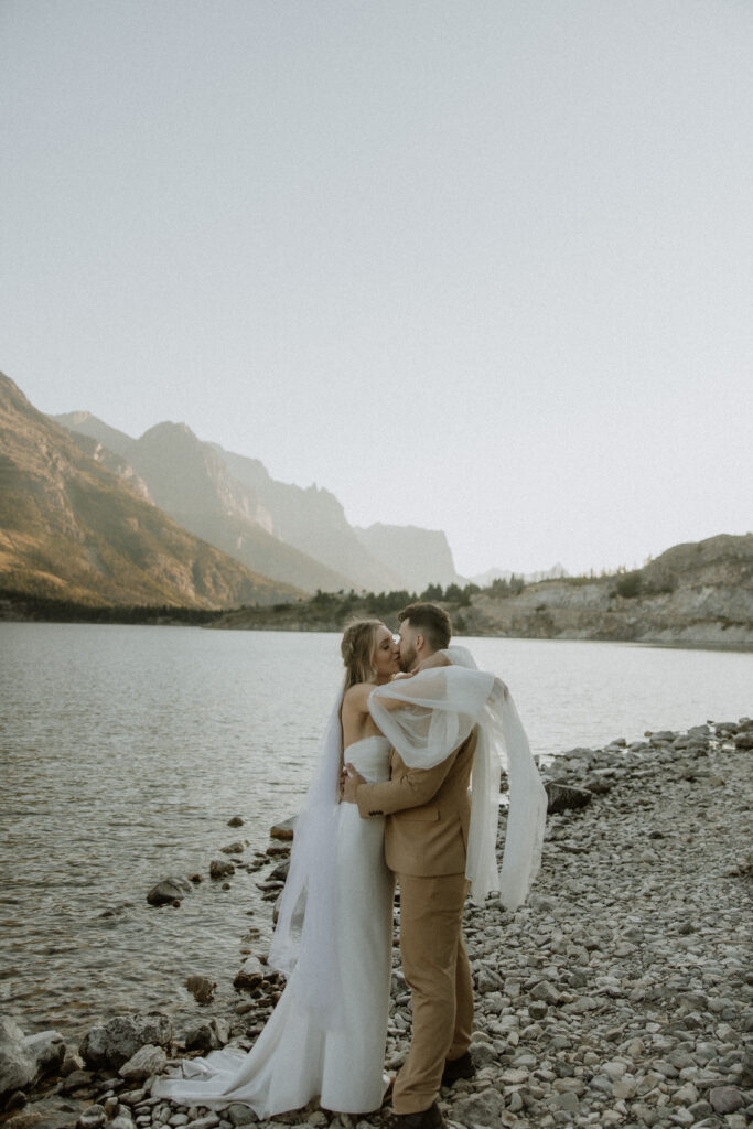 Groom, kissing the bride on the cheek