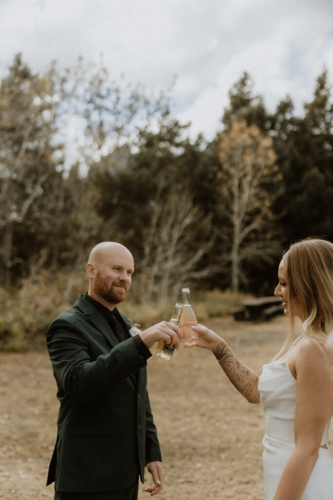 bride and groom celebrating their elopement with campagne