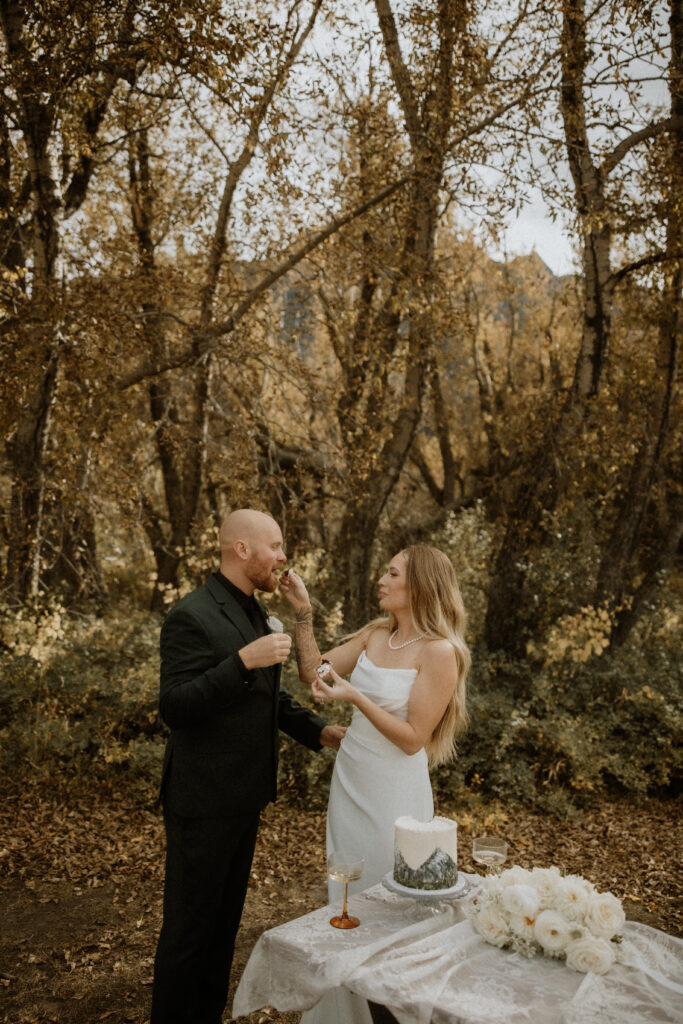 newlyweds trying their wedding cake