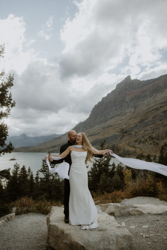 groom kissing the bride on the cheek