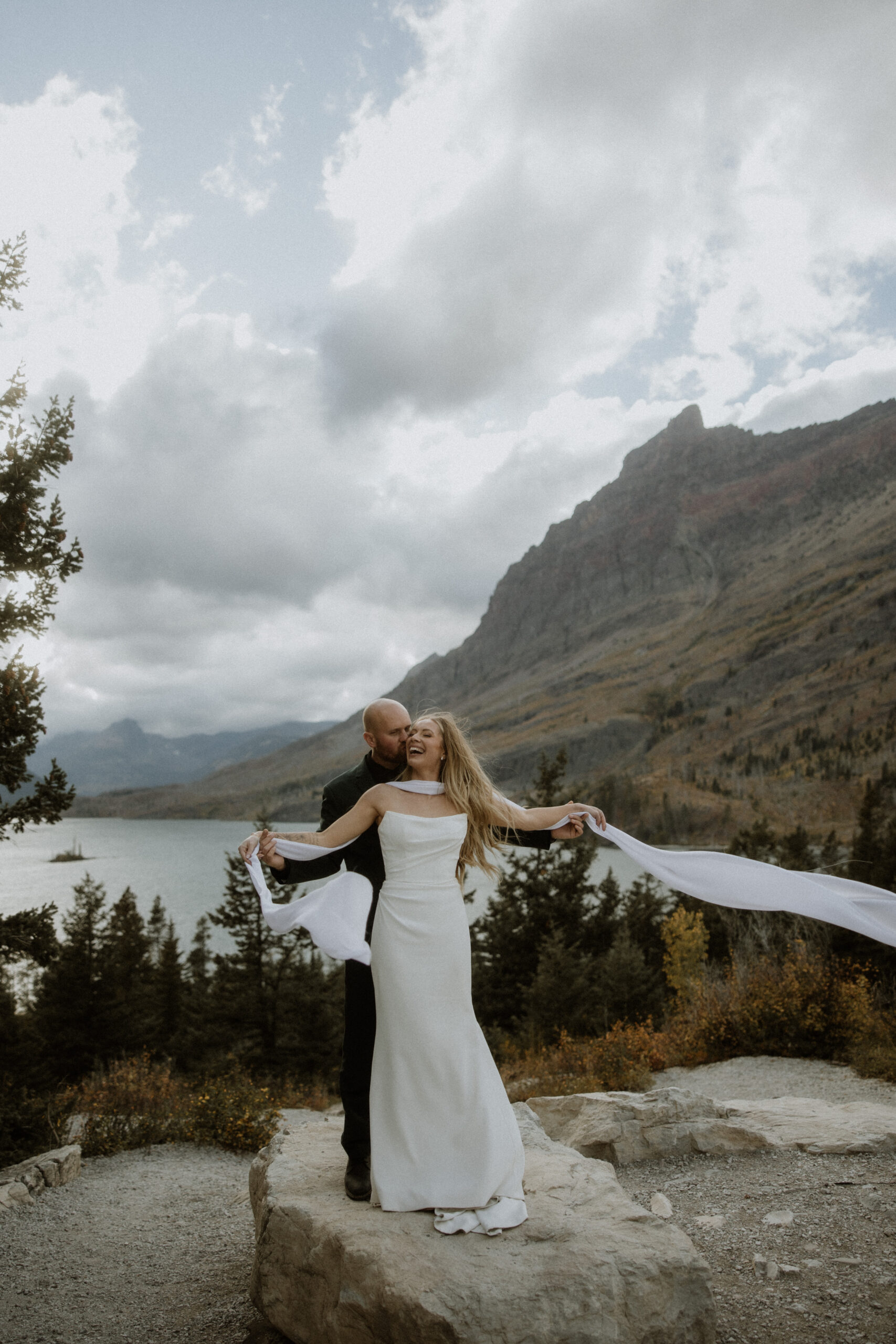 groom kissing the bride on the cheek