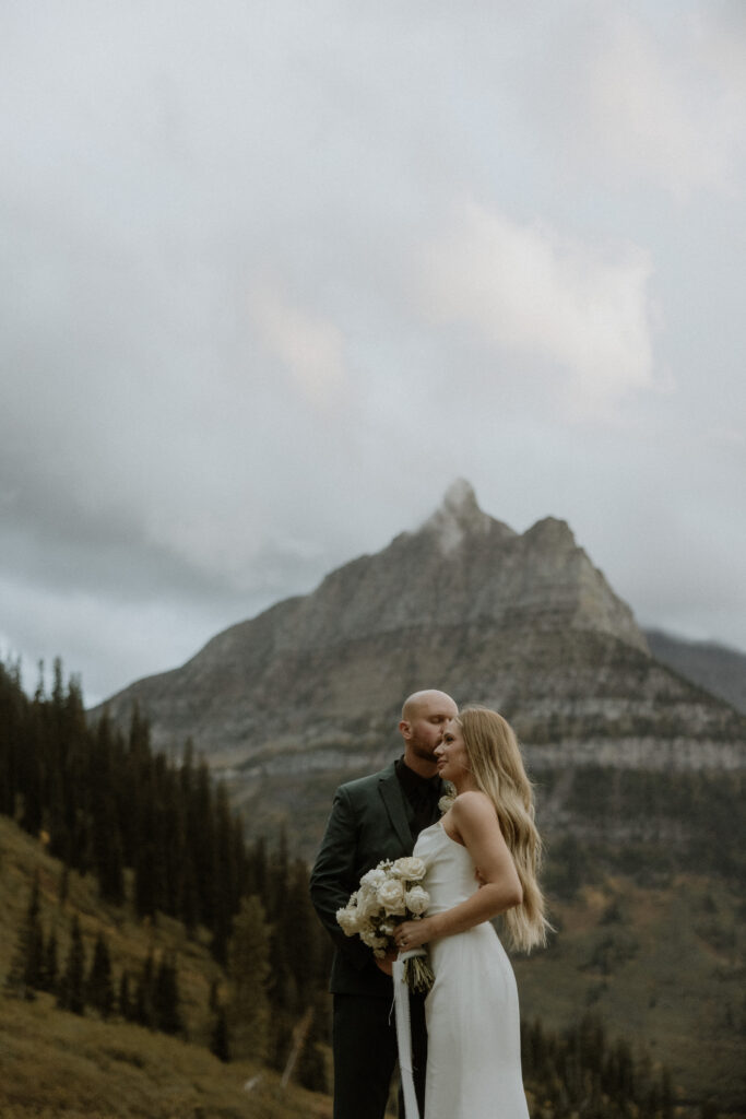 bride kissing the groom on the cheek