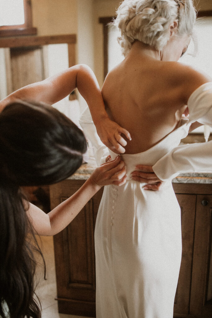 bride getting ready for her first look with the groom