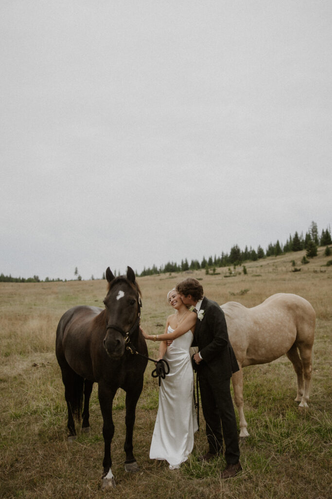 groom kissing the bride on the cheek