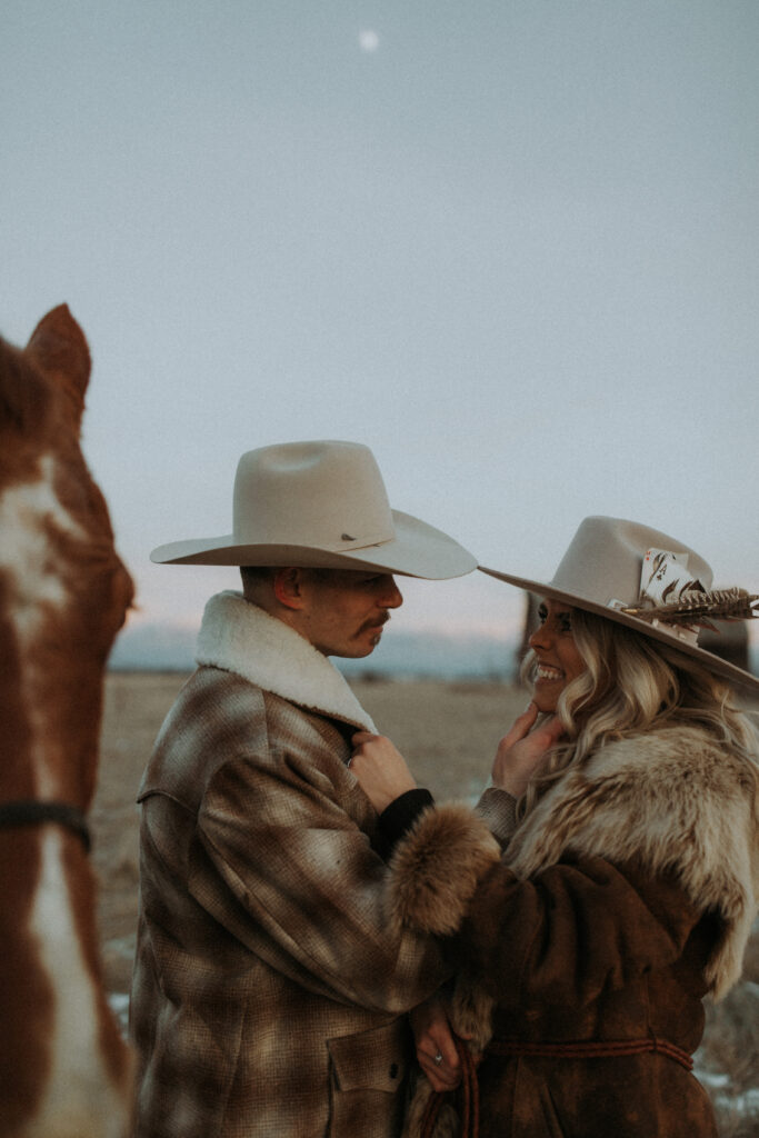 cute picture of the newly engaged couple smiling at each other