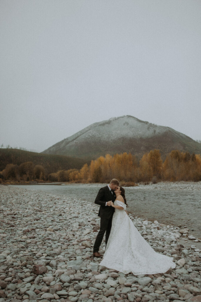 Groom, kissing the bride on the cheek