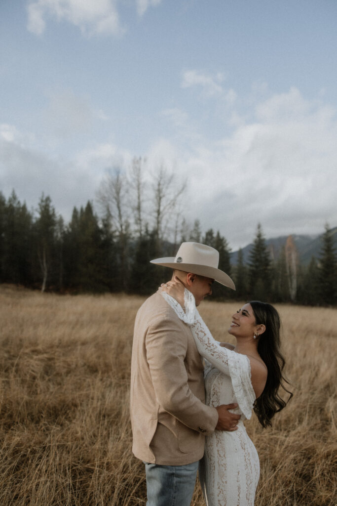 couple smiling at each other during their montana bridal photos