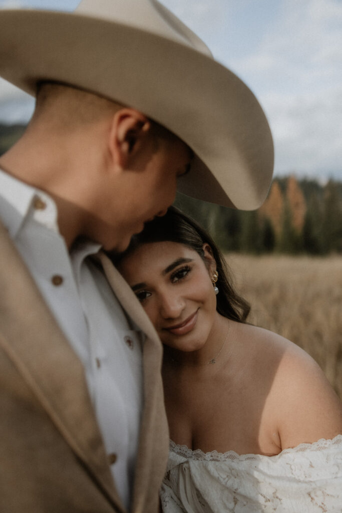groom kissing the bride on the forehead